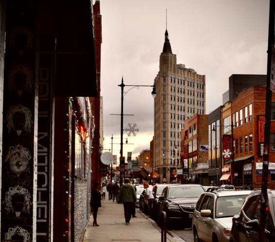 sidewalk in busy city with people walking