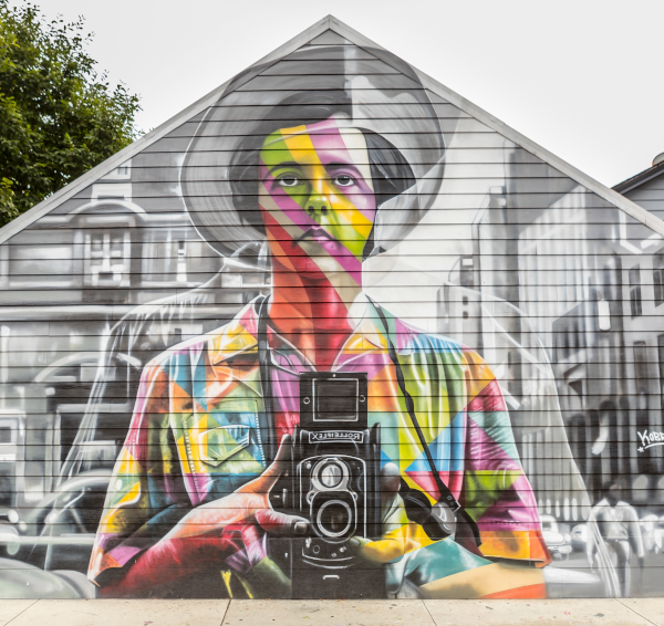 mural on building of woman with camera